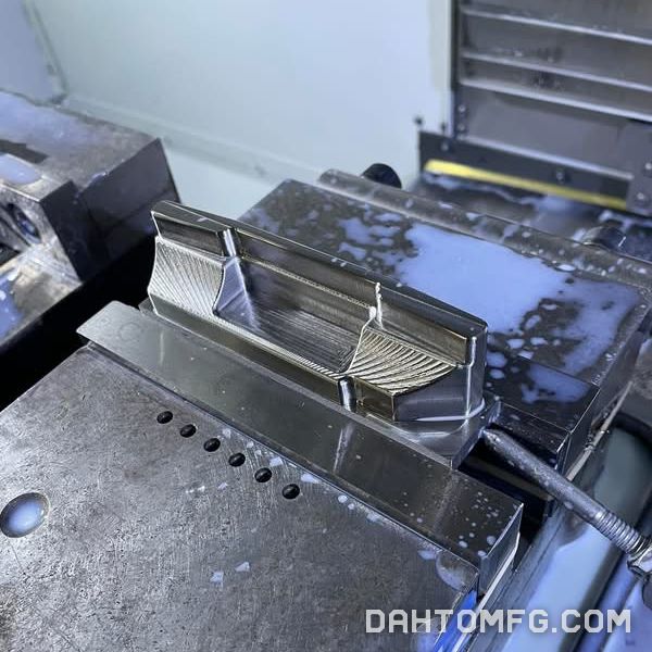 3D-surfaced aluminum part in the vise, viewed from the side