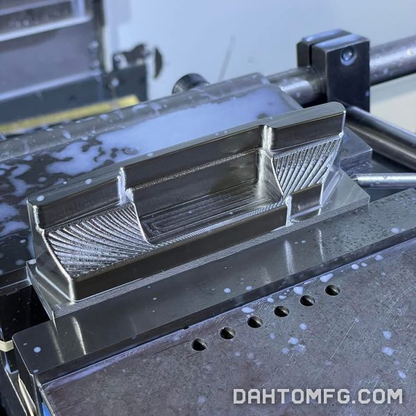 Aluminum part with 3D-surfaced faces held in a machine vise