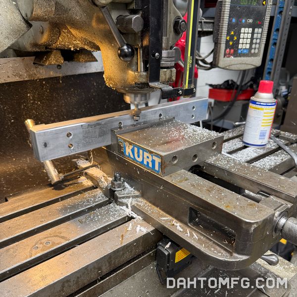Bridgeport manual mill with a Kurt vise, digital readout, and fresh chips