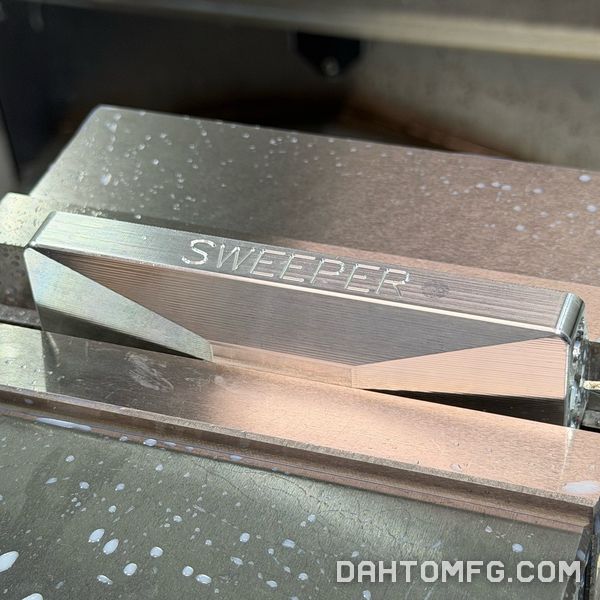 Engraved aluminum part held in a machine vise