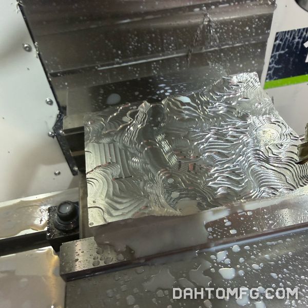 Terrain map in aluminum after roughing, showing step-down contours