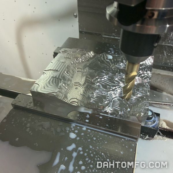 End mill roughing a topographic terrain map in an aluminum block